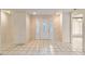 Inviting foyer with neutral tile flooring, ample lighting, and decorative front door at 6203 Courtside Dr # 21, Bradenton, FL 34210