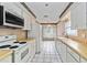 Functional kitchen with white appliances, tile backsplash, and dining nook at 6203 Courtside Dr # 21, Bradenton, FL 34210