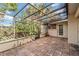 The enclosed tiled patio with screened cage and ceiling overlooks the lush backyard at 6203 Courtside Dr # 21, Bradenton, FL 34210