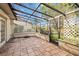 The enclosed back tiled patio offers a screened cage, a ceiling, and overlooks the landscaped backyard at 6203 Courtside Dr # 21, Bradenton, FL 34210