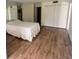 Spacious bedroom with wood floors, large closet, and mirrored wall at 647 Woodlawn Dr # 647, Bradenton, FL 34210