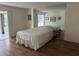 Bright bedroom with mirrored wall and sliding glass doors to the balcony at 647 Woodlawn Dr # 647, Bradenton, FL 34210