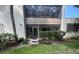 Charming condo exterior featuring lush greenery and a welcoming entrance at 647 Woodlawn Dr # 647, Bradenton, FL 34210