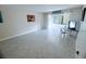 Bright, open living room with tile floors and a large window letting in natural light at 647 Woodlawn Dr # 647, Bradenton, FL 34210
