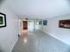 Open-concept living room featuring tile floors, neutral walls, and plenty of natural light at 647 Woodlawn Dr # 647, Bradenton, FL 34210