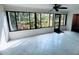 Enclosed sunroom with tile floors and windows overlooking garden at 647 Woodlawn Dr # 647, Bradenton, FL 34210