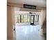 Bright sunroom with neutral tile and decorative curtains at 647 Woodlawn Dr # 647, Bradenton, FL 34210