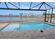 Beautiful screened pool overlooking a serene lake and neighboring homes at 650 Maldives Trl, Sarasota, FL 34234