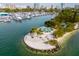 Panoramic aerial view of a marina and waterfront park, featuring lush landscaping, palm trees, and water views at 659 Maldives Trl, Sarasota, FL 34234