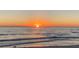 Tranquil sunset over the ocean, painting the sky with warm colors and the gentle waves on the shoreline at 659 Maldives Trl, Sarasota, FL 34234