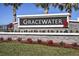 Beautiful stone Gracewater community sign with red flower landscaping at 659 Maldives Trl, Sarasota, FL 34234