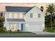 Charming two-story home featuring a two-car garage, tasteful landscaping and a welcoming light blue front door at 659 Maldives Trl, Sarasota, FL 34234