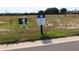 Vacant homesite ready for development, featuring a homesite marker and easy access to utilities at 659 Maldives Trl, Sarasota, FL 34234