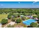 Aerial view of community recreation area with an ice rink, a playground, a parking lot, and green spaces at 6674 Coopers Hawk Ct, Lakewood Ranch, FL 34202
