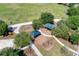 Aerial view of a community playground with swing sets, climbing structures, and a covered picnic area at 6674 Coopers Hawk Ct, Lakewood Ranch, FL 34202