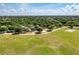Aerial view of community park with playground, walking path, trees, and open green space on a sunny day at 6674 Coopers Hawk Ct, Lakewood Ranch, FL 34202