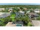 This aerial shows the property surrounded by mature trees and landscaping near a scenic lake at 6674 Coopers Hawk Ct, Lakewood Ranch, FL 34202