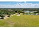 Aerial view of community park featuring a lake, volleyball court, playground and open green space at 6674 Coopers Hawk Ct, Lakewood Ranch, FL 34202