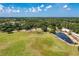 Aerial view of the community park with open field, trees, walking path, water feature and green lawn at 6674 Coopers Hawk Ct, Lakewood Ranch, FL 34202