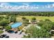 Aerial view of a community park with a playground, skating rink, shelter, and other recreational facilities at 6674 Coopers Hawk Ct, Lakewood Ranch, FL 34202