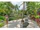 Relaxing backyard with a hammock, chairs, fire pit, and tropical landscaping for serene outdoor living at 6674 Coopers Hawk Ct, Lakewood Ranch, FL 34202
