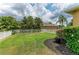 The expansive backyard features lush greenery, manicured landscaping, and a classic white picket fence at 6674 Coopers Hawk Ct, Lakewood Ranch, FL 34202