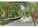 Tranquil backyard retreat with swaying palm trees, lush tropical landscaping, and a relaxing hammock at 6674 Coopers Hawk Ct, Lakewood Ranch, FL 34202