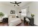 Bright bedroom featuring wood floors, large window, and a vanity with black accents at 6674 Coopers Hawk Ct, Lakewood Ranch, FL 34202