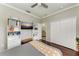 Bedroom featuring wood floors, ceiling fan, and large closet with white shelving at 6674 Coopers Hawk Ct, Lakewood Ranch, FL 34202