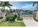 Stunning home with a three-car garage, lush landscaping, and a paver walkway leading to the front door at 6674 Coopers Hawk Ct, Lakewood Ranch, FL 34202