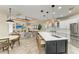 Open concept kitchen with a large island, pendant lighting, stainless steel appliances, and adjoining living room at 6674 Coopers Hawk Ct, Lakewood Ranch, FL 34202