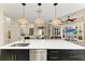 Open-concept kitchen with a large island, pendant lighting, and a view into the living room and breakfast nook at 6674 Coopers Hawk Ct, Lakewood Ranch, FL 34202