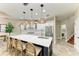 Bright kitchen features a spacious island with seating, stainless steel appliances, and a view of the laundry room at 6674 Coopers Hawk Ct, Lakewood Ranch, FL 34202