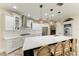 Bright kitchen featuring white cabinets, stainless steel appliances, and a large island with bar seating at 6674 Coopers Hawk Ct, Lakewood Ranch, FL 34202