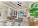 Inviting living room with built-ins, plush seating, and a large sliding glass door leading to the pool area at 6674 Coopers Hawk Ct, Lakewood Ranch, FL 34202