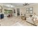 Bright living room with tile floors, neutral walls, modern furniture and dining area overlooking beautiful outdoor scenery at 6674 Coopers Hawk Ct, Lakewood Ranch, FL 34202
