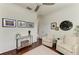 Bright living room offers wood floors, cozy seating, and decorative art at 6674 Coopers Hawk Ct, Lakewood Ranch, FL 34202