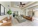 Open-concept living room with modern furniture, tile flooring, and view into the kitchen and patio at 6674 Coopers Hawk Ct, Lakewood Ranch, FL 34202