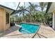Private pool enclosed with a screened lanai, surrounded by tropical foliage for a serene oasis at 6674 Coopers Hawk Ct, Lakewood Ranch, FL 34202
