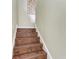 Hardwood staircase and decorative wall design leading to the upper level of the home at 6674 Coopers Hawk Ct, Lakewood Ranch, FL 34202