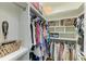 Organized walk-in closet with custom white shelves, hanging racks, baskets and accessories storage at 6674 Coopers Hawk Ct, Lakewood Ranch, FL 34202