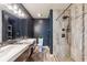 Modern bathroom with double sinks, tiled shower, and dark blue walls at 6708 11Th Nw Ave, Bradenton, FL 34209