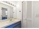 Well-lit bathroom featuring a vanity with a blue cabinet and a large mirror and access to the toilet and shower area at 6708 11Th Nw Ave, Bradenton, FL 34209