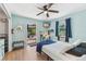 Relaxing bedroom featuring a queen bed, a mounted television, and a door that leads to a covered patio at 6708 11Th Nw Ave, Bradenton, FL 34209