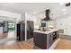 Modern kitchen featuring stainless steel appliances, a large island, and stylish finishes at 6708 11Th Nw Ave, Bradenton, FL 34209