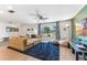 Cozy living room with stylish furnishings, including a sectional sofa, area rug, and large windows at 6708 11Th Nw Ave, Bradenton, FL 34209