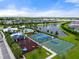Aerial view of neighborhood amenities including a playground, sport courts, pool and water feature at 6708 162Nd E Pl, Parrish, FL 34219