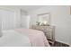 Bright bedroom featuring a dresser with a mirror, neutral walls, and hardwood flooring at 6708 162Nd E Pl, Parrish, FL 34219
