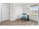 Bedroom with plank flooring has a bright window and a side table with lamp at 6708 162Nd E Pl, Parrish, FL 34219