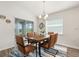 Dining room with a modern chandelier, a wood dining table, and seating for six at 6708 162Nd E Pl, Parrish, FL 34219